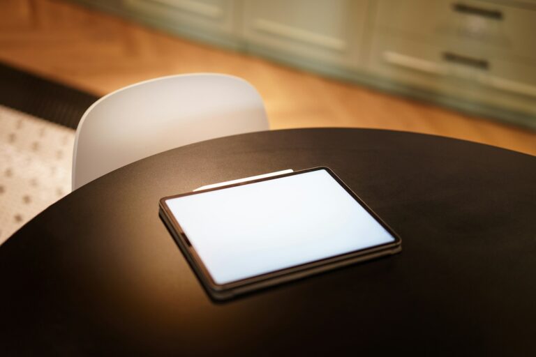 A cell phone sitting on top of a wooden table