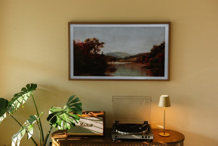 An artwork is displayed above a record player.